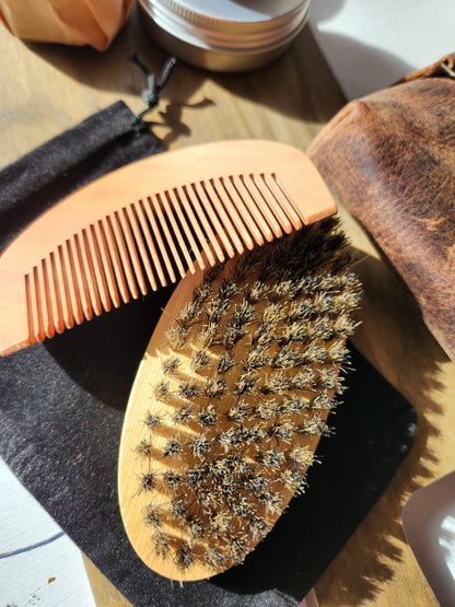 beard brush and comb on velvet bag with wood background.